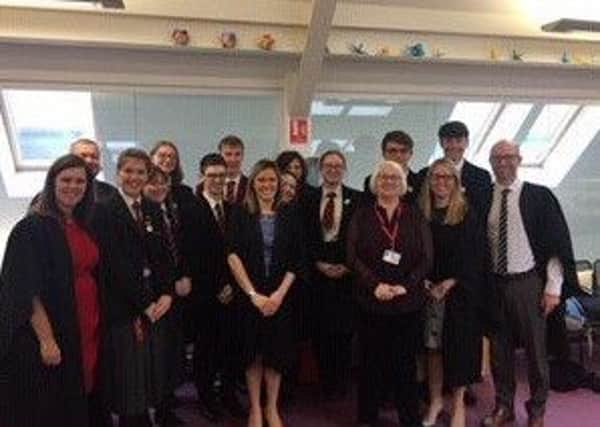 Joan Salters MBE pictured with staff and students at Ballyclare High.