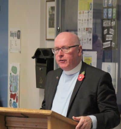 Reverant Tom Greer officiating remembrance service.