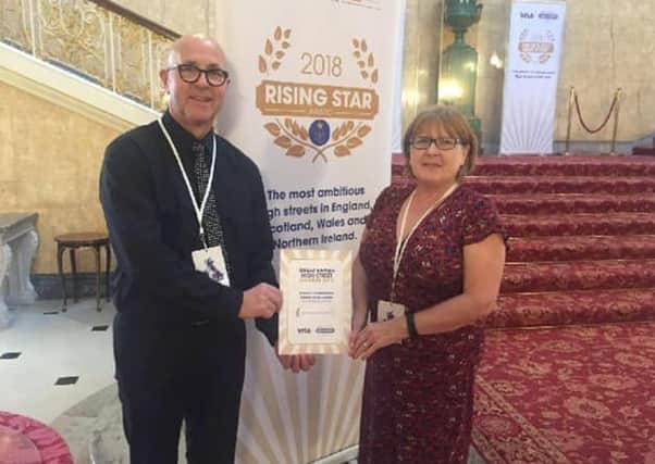 Marc Dobbin, vie-chairman, Larne Traders' Forum and Lynda Hill, The Larne Renovation Generation, collected Larne's award.