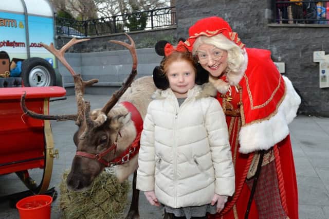 Leah Johnston met Mrs Mary Claus and Rudolph at the Carrickfergus Christmas lights switch on. INCT 47-002-PSB