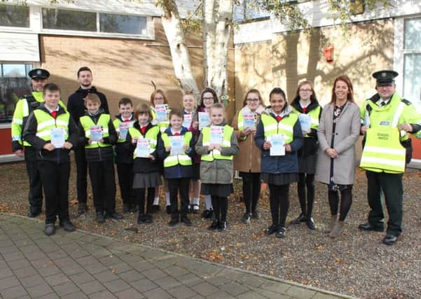 Police and pupils at Tullygally Primary School who took part in a leaflet drop highlighting the School Watch Scheme, Included are School Principal Mrs Kirsty Andrews, Vice Principal Mr Johnny Guy and Constables Gary McKeown and Tony Acton of Brownlow Neighbourhood Policing Team.