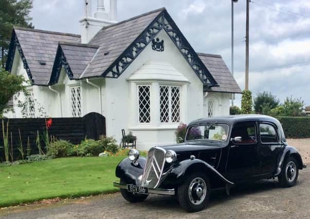 An 80-year-old car, a 1938 Citroen Traction Avant Light 12, pays a visit to a 400-year-old house, Shane's Castle Gate Lodge in Antrim