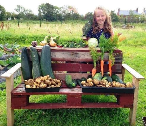 Katelyn Shaw with produce grown at Greenisland Allotment Gardens.