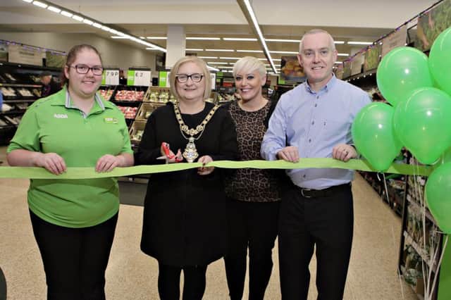 Causeway Coast and Glens Council Mayor Cllr Brenda Chivers cutting the 'Green Ribbon', marking the completed refurbishment at Coleraine ASDA, pictured with Community Champion Shannon Linton, ASDA Deputy Manager Ursula Leonard and ASDA Manager Roy Warke.