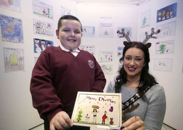 Woodlawn PS pupil, Curtis McFerran, whose Christmas card was selected as the overall winning design, pictured with Mayor Cllr Lindsay Millar.