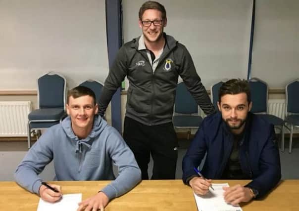 Dungannon Swifts manager Kris Lindsay pictured with his new club captain, Christopher Hegarty and vice-captain, Seanan Clucas, who have both signed contract extensions.