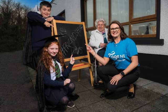 Pictured extending the hand of friendship to the local community at the Macklin Care Homes #FriendshipDays Launch are (l-r), local school children from Ballycastle Primary School, Muirin Hughes and Eamon Gomez with resident Elizabeth Cassidy and Nadine Campbell from Age NI.