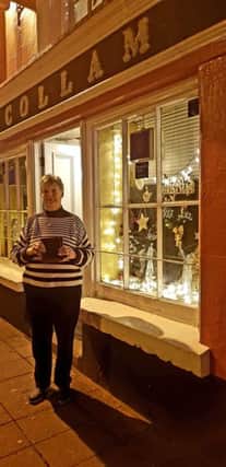 Ann Stewart from J.J. McCollams, runner-up of the Christmas window competition in Cushendall.