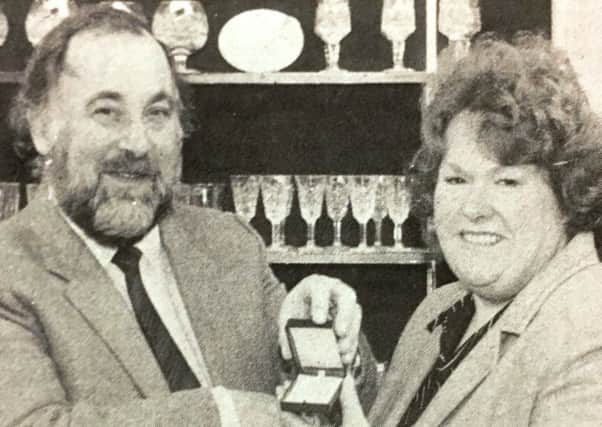 Mr Alan Stracey presents Mrs Maureen Woolridge with a necklace as first prize in a Times competition in 1985.