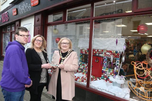 Jane Cole and Colm McIlver from Can Can Bazaar, winner of the Christmas window competition in Ballymoney, receive their award from the Mayor of Causeway Coast and Glens Borough Council Councillor Brenda Chivers.