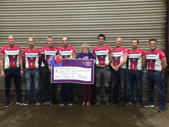 Pictured are Seamus OConnell and Agivey Cycling Club presenting Antoinette from the Hospice Kilrea Support Group with a cheque for Â£22,895.
