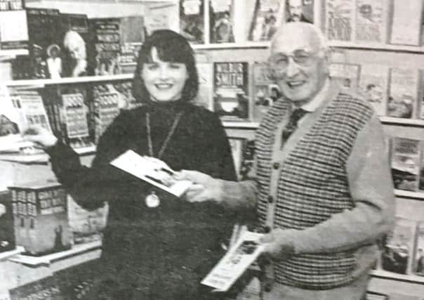 Lesley Price, owner of Dromore's first book shop, Bridge Books, pictured in 1995 placing books on the shelf by local author Andrew Dolingham,