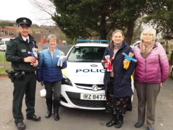 Antrim and Newtownabbey PSNI taking receipt of a second batch of Trauma Teddies from crafting group, Easy Come, Easy Sew.