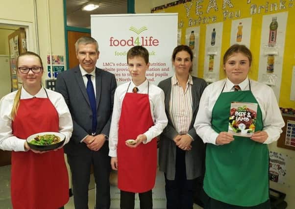 Ian Stevenson, LMC Chief Executive, pictured with Mrs Lisa Donnan, Home Economics teacher and pupils from Friends School, Lisburn during the launch of LMCs post-primary school cookery demonstrations