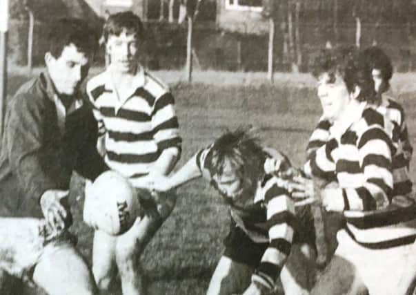 The first fifteen take on North during a match in 1985.