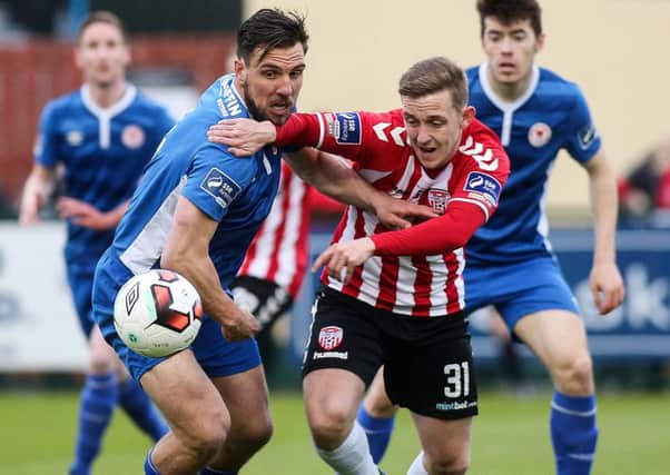 Striker Mikhail Kennedy tussles with the then St. Patrick's Athletic defender Gavin Peers.