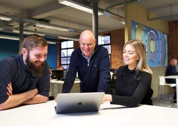 John Harkin (middle) Founder and Director of Alchemy Technology Services with successful recruits from the companys first Academy, Technical Analyst Jordan Cairns and PMO Analyst Olivia Skuce.