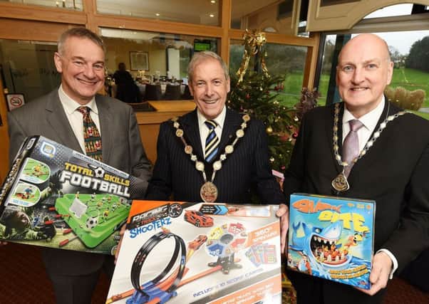 (l-r) Colin McDonald, Councillor Uel Mackin; Mayor of Lisburn & Castlereagh City Council and Garry MacDonald; Chamber president with some of the toys donated to Barnardos at the Lisburn Chamber Annual Charity Christmas Lunch and Toy Appeal.