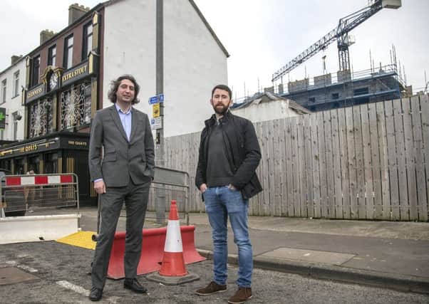 Paul McNaught (left) from the Department for Communities (DfC) and Simon Crawley, the owner of Quays Bar in Portrush.  An award of Â£354,000 in Urban Development Grant funding from DfC will help the Quays Bay to build an extension, making use of vacant land in the town centre.