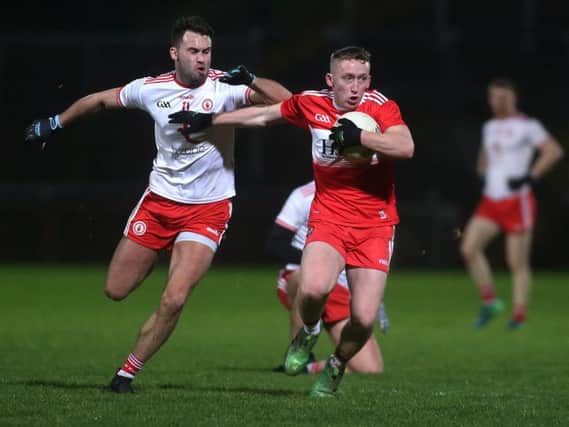 Derry's Sean Quinn takes on Kyle Coney during the McKenna Cup Group game before Christmas.