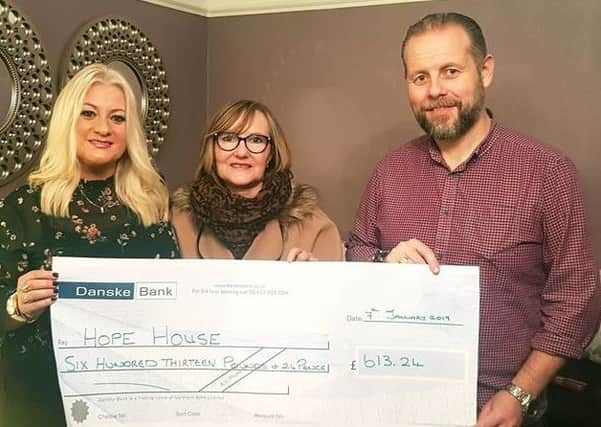 Carlyn and Tom Nicholl presented a cheque to Dawn McConnell, from the Hope House charity.