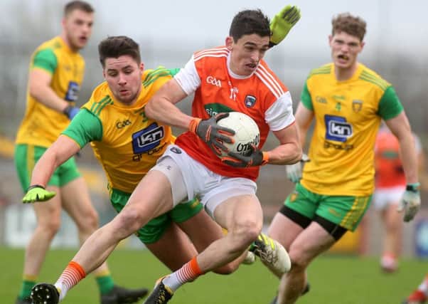 Armagh's Rory Grugan with Donegal's Brendan McCole and Conor Morrison