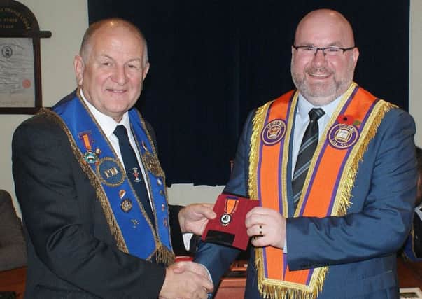 Bro. Morris Cairns from Diamond LOL 1422 receives his 50 year Service Jewel from Bro. Stephen Foster of LOL 591.
The special presentation was made in the presence of a large gathering of Diamond LOL 1422 members in the Diamond Memorial Orange Hall, Muckamore.
Bro. Morris Cairns was initiated into Fawny Fort LOL 2048 City of Londonderry Grand Lodge Number Five in May 1966 and transferred into the Diamond LOL 1422 Antrim District No. 13 in 1973.
