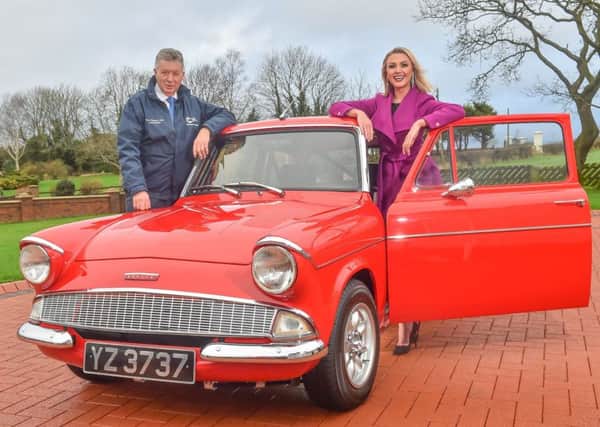 Gearing up for the show with a classic Ford Anglia are Martin Cromwell and Meaghan Green from the shows organising committee.