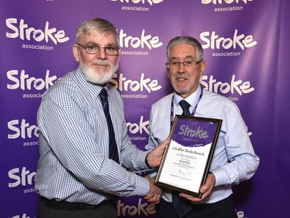 Larne Stroke survivor and volunteer George Stewart, receiving his nomination certificate from Stroke Association committee member Peter Deazley.