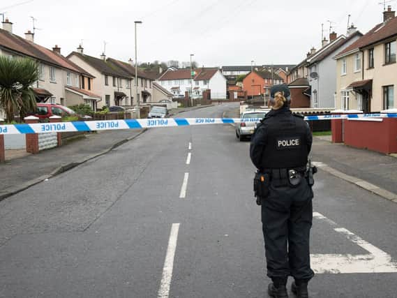A P.S.N.I officer at the scene of one of the security alerts in Londonderry. (Photo: Pacemaker)