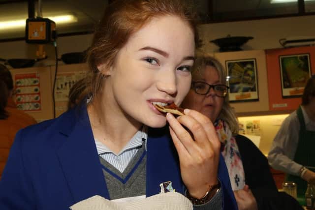 A St Killian's pupil taking a break from open day duties to enjoy a treat.
