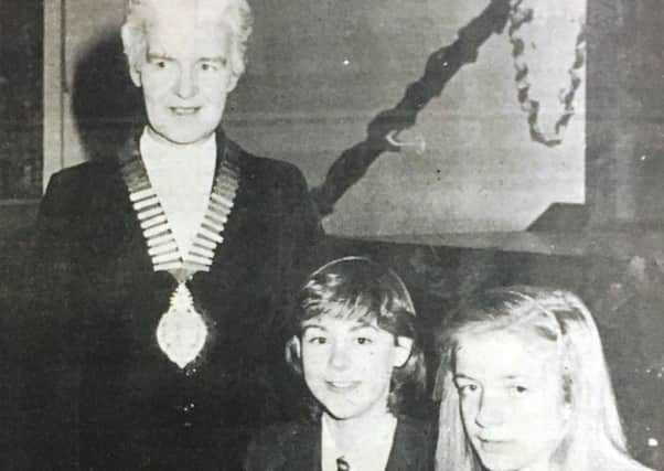 Miss Agnes McCosh, President of the Soroptimists International of Lurgan with Donagh McCluskey and Louise Tipping from St Michael's Senior High School at the public speaking competition in 1981.