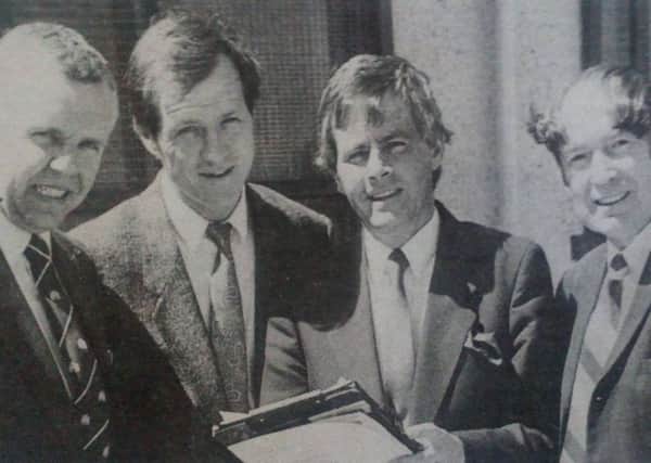 Tom Sloan (second left) discusses his plans for his testimonial match at Sandy Bay with Sgt. Tom Crawford of Larne RUC, Ronnie Blair of Larne Council, Victor Marcus of Larne Football Supporters' Club and Ian Chalmers, Larne Council. 1989.