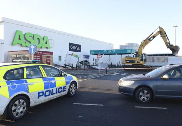 A digger was used to steal two cash machines at the Asda store in Antrim. Considerable damage was caused to a building during the incident. Picture by Arthur Allison/Pacemaker Press