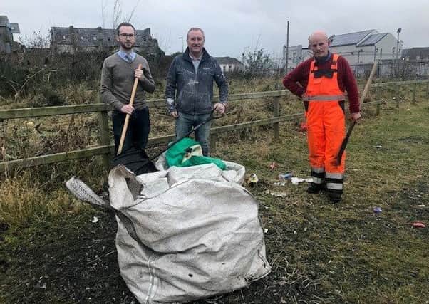 Cllr Declan McAlinden and SDLP representative Ciaran Toman cleaning up the waste ground at North St car park
