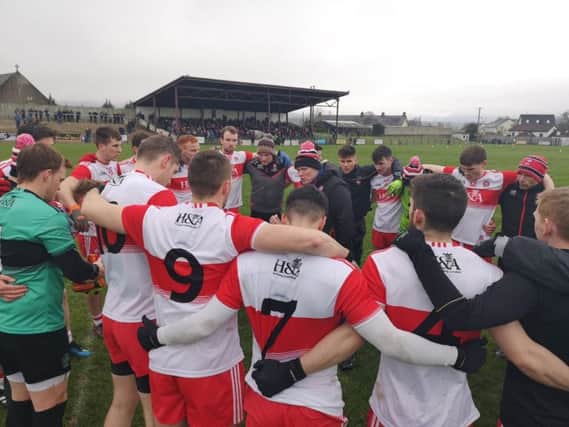 Derry manager Damin McErlain talks to his players after their second win in two games aginats London in Ballinascreen on Sunday.