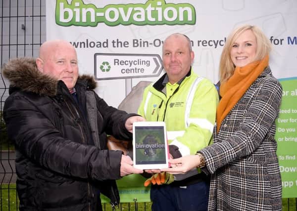 Mid & East Antrim Councill James McKeown takes a look at the Bin-ovation app with Senior HRC attendant David Ewing and Education Officer Catherine Hunter.