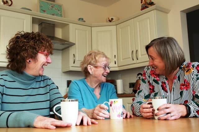 Hazel Bell, chair of Choice Housing Ireland, Roberta Cush, tenant at Whitehouse Court and Lorna Brown, Choice Asset Project Liaison officer, enjoying a cuppa at the renovated Edwardian style housing development.