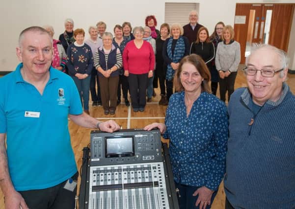 Michael Loughran, of Islandmagee Community Centre, at the Gobbins, with Hilary Bailey and Eric Bailey and the choir with the new sound desk.