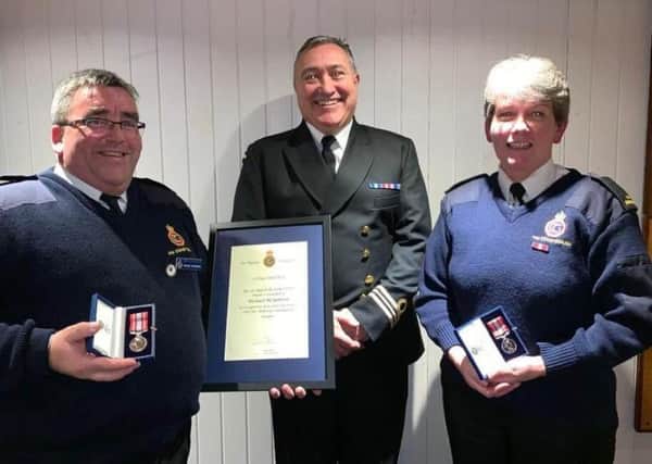 Michael McSparron (left) was presented with his 30 year service award with Mandy Johnston who received her 20 year service award from Jeff Hobson, senior coastal operations officer, HM Coastguard.
