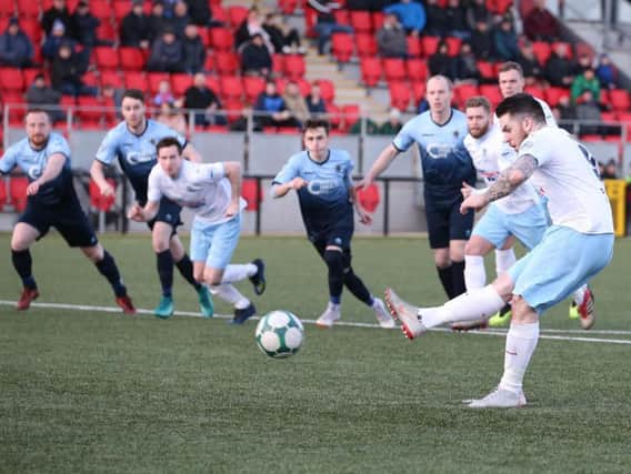 Ballymena United's Cathair Friel fires home from the penalty spot.
