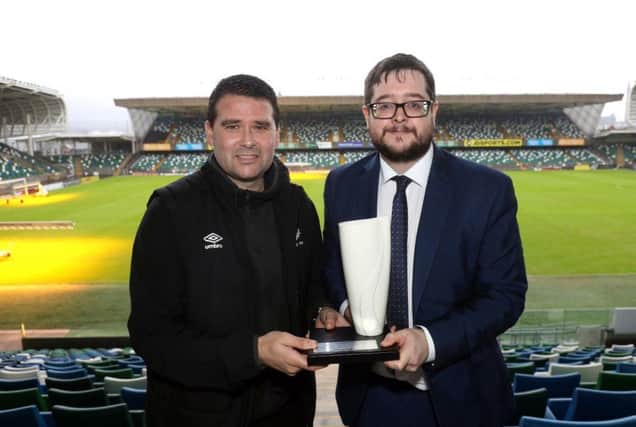 Linfield manager David Healy collects the Belleek trophy from NIFWA Chairman Keith Bailie