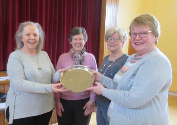 The winning Templepatrick team Roberta Stinson, Hilary Becket and Carol Borland received a trophy presented by area president Ann Graham.