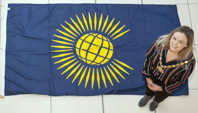 The Deputy Mayor of Mid and East Antrim, Cllr Cheryl Johnston, with the Commonwealth flag.