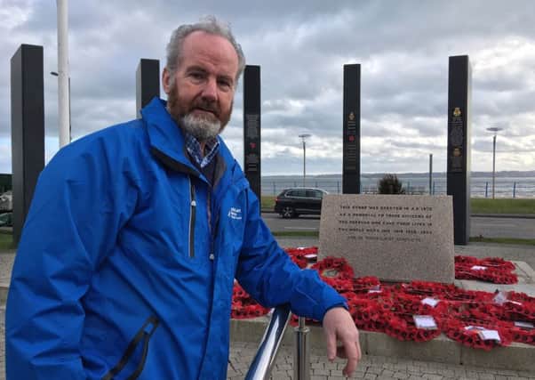 Cllr Billy Henry, who served in the RUC and armed forces during The Troubles, at the war memorial in Carrickfergus