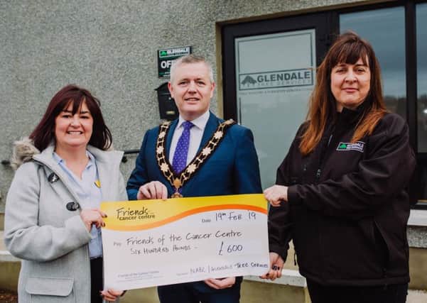Mayor of Antrim and Newtownabbey, Councillor Paul Michael and Kirstie Cameron, owner of Glendale Tree Services present a cheque for £600 to Claire Hogarthy, Fundraising Manager with Friends of the Cancer Centre.