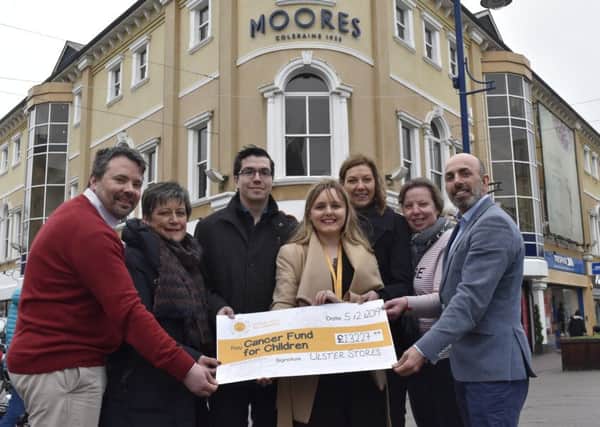 Simon Fisher, Thelma Wray, Nathan Chapman, Suzanne Conkey, Lorraine and Simon Colquhoun from Ulster Stores/Moores present Suzanne o'Loughlin (Regional Fundraiser Cancer Fund for Children) with  £13,447.44 from their 2018 charity partnership.