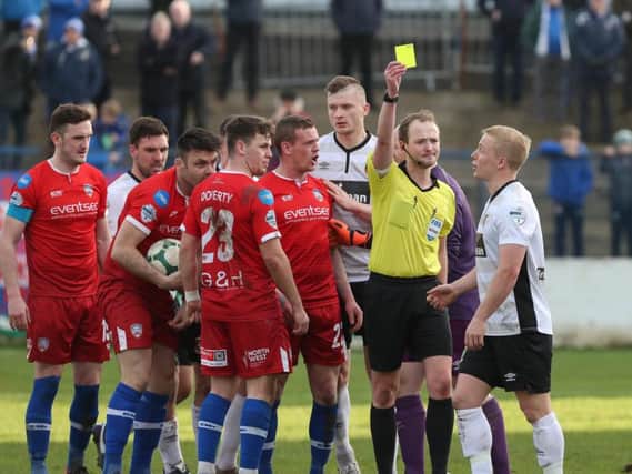 Conor Pepper is shown a yellow after Coleraine were awarded a third penalty