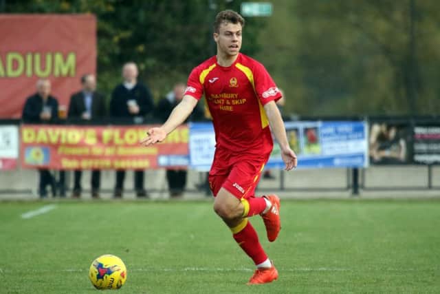 Banbury United's Charlie Hawtin was the victim of a late challenge by Redditch United's Michael McGrath