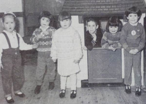 The children of Clough and District Pre-School Play Group who raised money through a sponsorship bike race for this playhouse and trampoline. 1989.